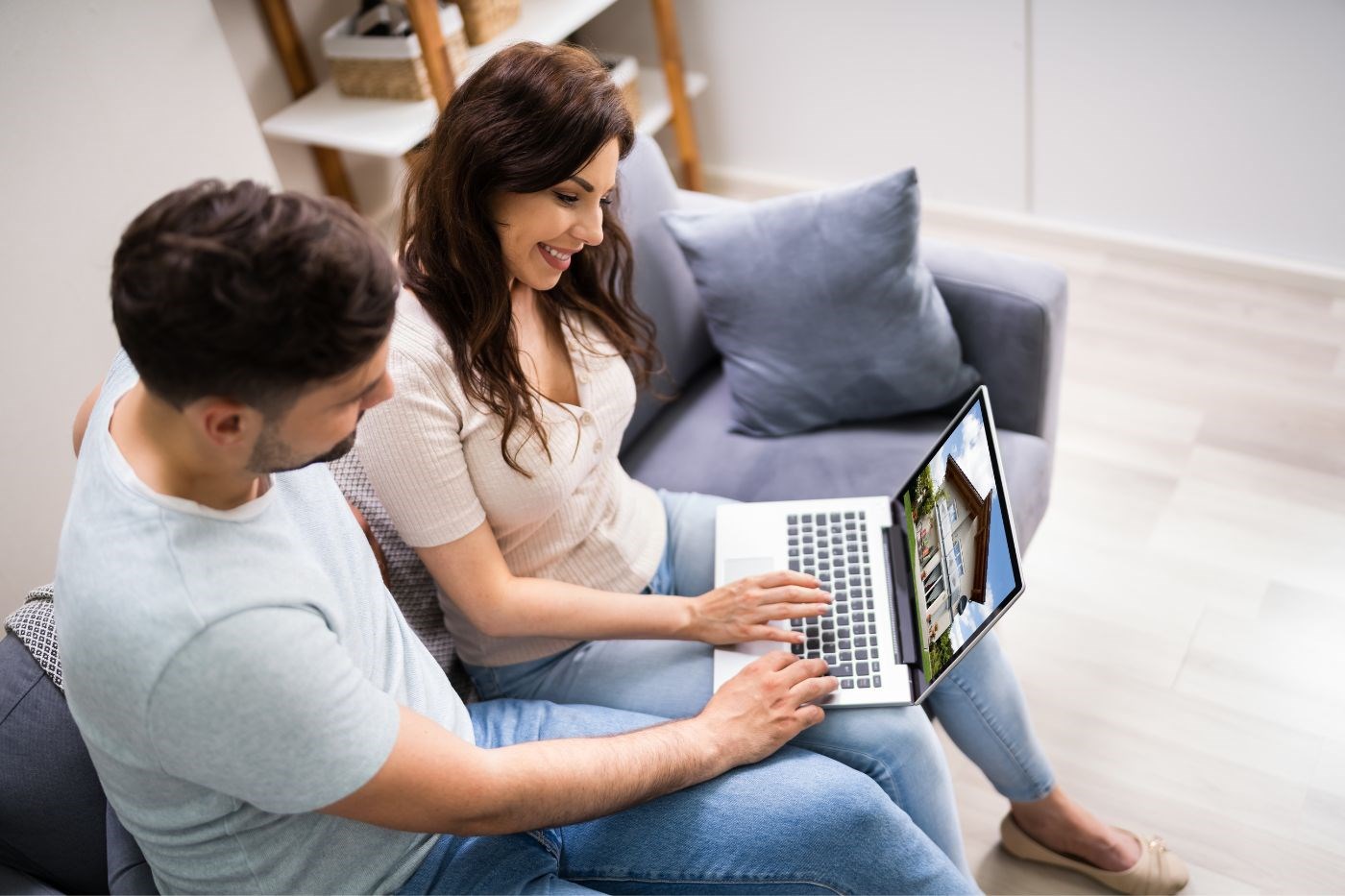 A couple looking to buy a property on a laptop